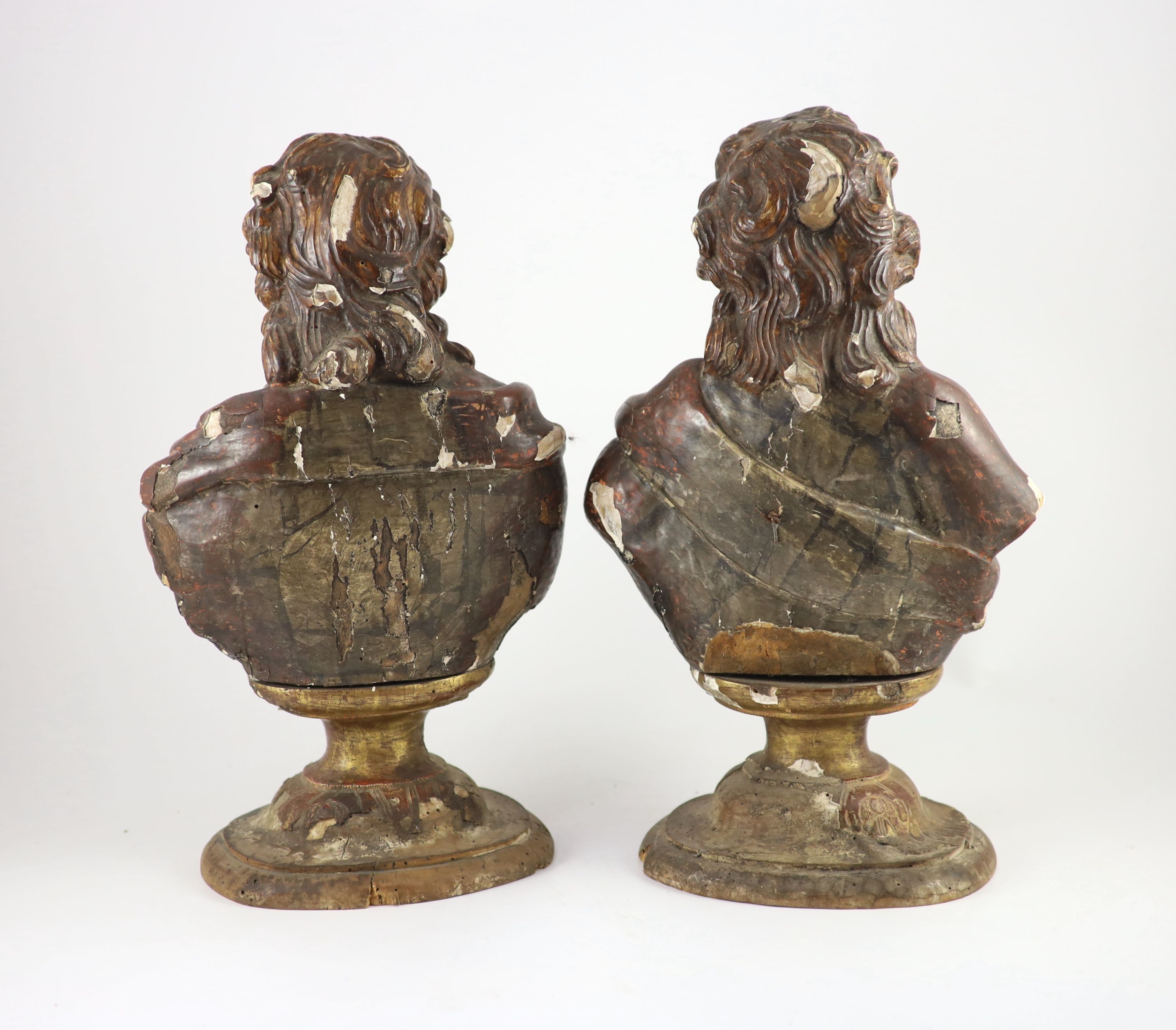 A pair of early 19th century Spanish carved and painted busts of saints, width 25cm approx. height 44cm